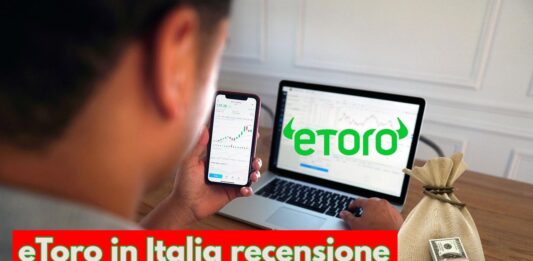 trader che investe con pc con logo di eToro