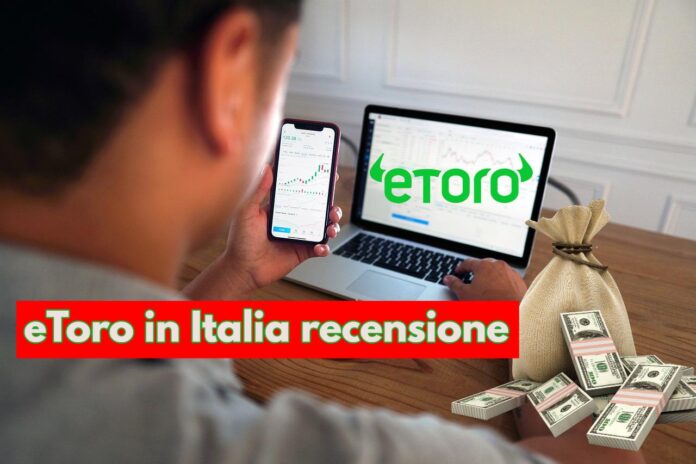 trader che investe con pc con logo di eToro