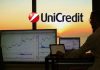 chart di trading e logo Unicredit sullo sfondo