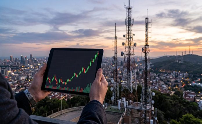 tablet con grafico a candele e sullo sfondo antenna Tlc
